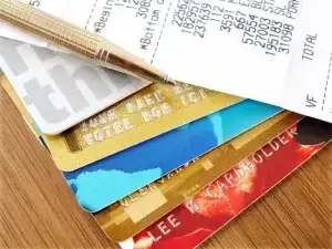 credit cards laid on table with receipt and pen on top