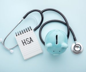 Health Savings Account (HSA) with a piggy bank and stethoscope 