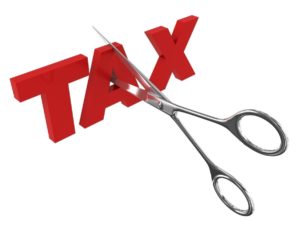 Scissors cutting the word "tax" for manufacturers