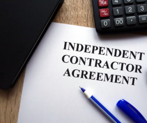 Independent Contractors - Agreement with calculator and pen for signing