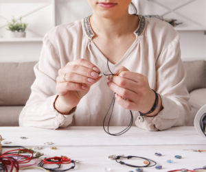 Woman making jewelry deciding whether it's a hobby or business