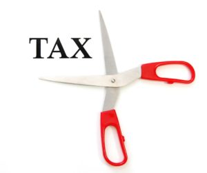 Scissors cutting the word "tax"