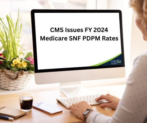 Woman at computer with CMS Issues FY2024 Rates on screen
