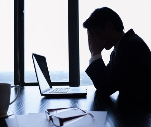 Worried businessman looking at laptop